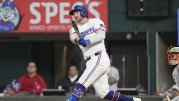Jun 17, 2024; Arlington, Texas, USA; Texas Rangers designated hitter Robbie Grossman (4) follows through on a two-run home run against the New York Mets during the third inning at Globe Life Field. Mandatory Credit: Jim Cowsert-USA TODAY Sports