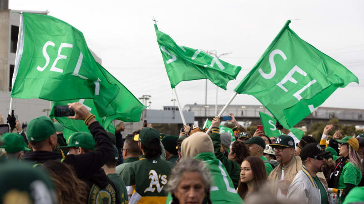 Mar 28, 2024; Oakland, California, USA; Oakland Athletics fans wave “Sell” flags to protest ownership plans to move to the franchise to Las Vegas, before a game between the Athletics and Cleveland Guardians at Oakland-Alameda County Coliseum. Mandatory Credit: D. Ross Cameron-USA TODAY Sports