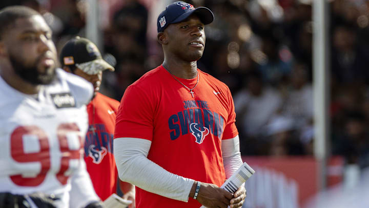 Houston Texans head coach DeMeco Ryans watches players warm up during training camp practice at the Houston Methodist Training Center.