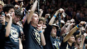 The Purdue student section shakes keys at a volleyball match