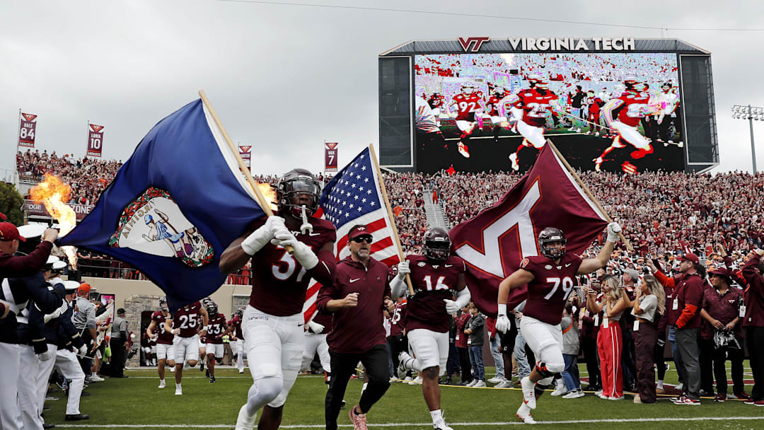 Oct 26, 2024; Blacksburg, Virginia, USA; Virginia Tech Hokies head coach Brent Pry runs onto the field before playing against the Georgia Tech Yellow Jackets at Lane Stadium. Mandatory Credit: Peter Casey-Imagn Images