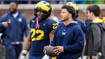 Former Michigan running back Blake Corum talks to running back Justice Haynes (22) at warm up before the spring game at Michigan Stadium in Ann Arbor on Saturday, April 19, 2025.