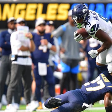 Oct 23, 2022; Inglewood, California, USA; Seattle Seahawks running back Kenneth Walker III (9) moves the ball against Los Angeles Chargers cornerback J.C. Jackson (27) during the first half at SoFi Stadium.