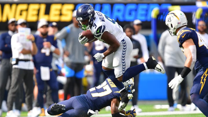 Oct 23, 2022; Inglewood, California, USA; Seattle Seahawks running back Kenneth Walker III (9) moves the ball against Los Angeles Chargers cornerback J.C. Jackson (27) during the first half at SoFi Stadium.