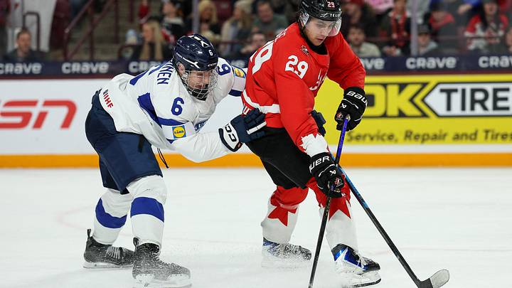 Dec 31, 2025; Minneapolis, Minnesota, UNITED STATES; Canada forward Michael Hage (29) skates with the puck as Finland defenseman Juho Piiparinen (6) defends during the second period in group play during the 2026 IIHF World Junior Championship at 3M Arena. Mandatory Credit: Matt Krohn-Imagn Images