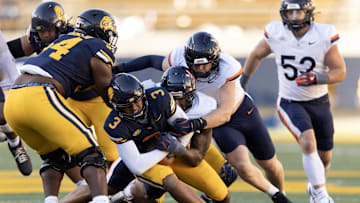 Nov 1, 2025; Berkeley, California, USA; California Golden Bears quarterback Jaron-Keawe Sagapolutele (3) is sacked by a Virginia Cavaliers defensive end Cazeem Moore (6) during the fourth quarter at California Memorial Stadium. Mandatory Credit: D. Ross Cameron-Imagn Images