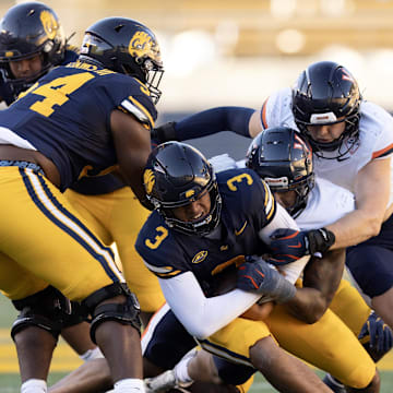 Nov 1, 2025; Berkeley, California, USA; California Golden Bears quarterback Jaron-Keawe Sagapolutele (3) is sacked by a Virginia Cavaliers defensive end Cazeem Moore (6) during the fourth quarter at California Memorial Stadium. Mandatory Credit: D. Ross Cameron-Imagn Images