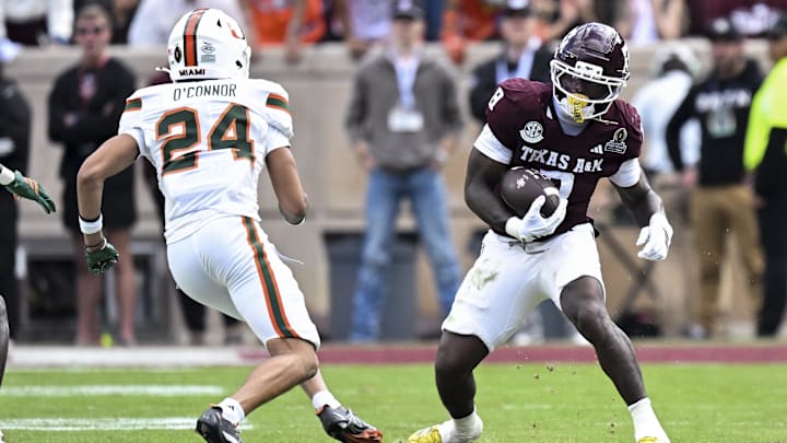 Dec 20, 2025; College Station, TX, USA; Texas A&M Aggies running back Le'Veon Moss (8) runs the ball as Miami Hurricanes defensive back Ethan O'Connor (24) defends during the second half at Kyle Field. Mandatory Credit: Maria Lysaker-Imagn Images