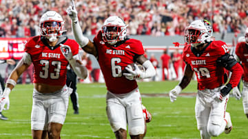 Nov 21, 2025; Raleigh, North Carolina, USA; NC State Wolfpack defensive back Devon Marshall (6) celebrates a down and runs towards the JROTC  to celebrate during the first half of the game against Florida State Seminoles at Carter-Finley Stadium. Mandatory Credit: Jaylynn Nash-Imagn Images