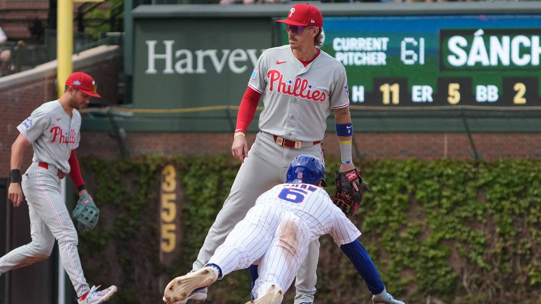Apr 23, 2026; Chicago, Illinois, USA; Chicago Cubs center fielder Matt Shaw (6) steals second base as Philadelphia Phillies second baseman Bryson Stott (5) stands nearby during the fifth inning at Wrigley Field. Mandatory Credit: David Banks-Imagn Images