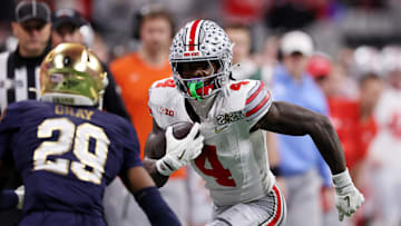 Jan 20, 2025; Atlanta, GA, USA; Ohio State Buckeyes wide receiver Jeremiah Smith (4) runs with the ball against the Notre Dame Fighting Irish during the first half the CFP National Championship college football game at Mercedes-Benz Stadium. Mandatory Credit: Brett Davis-Imagn Images
