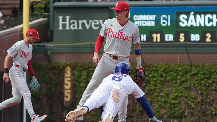 Apr 23, 2026; Chicago, Illinois, USA; Chicago Cubs center fielder Matt Shaw (6) steals second base as Philadelphia Phillies second baseman Bryson Stott (5) stands nearby during the fifth inning at Wrigley Field. Mandatory Credit: David Banks-Imagn Images