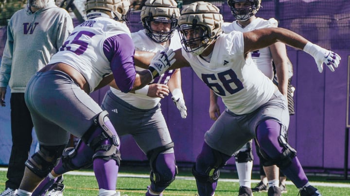 Soane Faasolo (68) takes on Michael Watkins during spring line drills. 