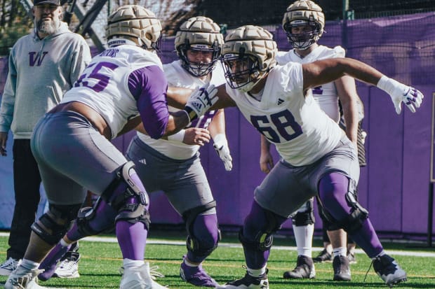 Soane Faasolo (68) takes on Michael Watkins during spring line drills. 