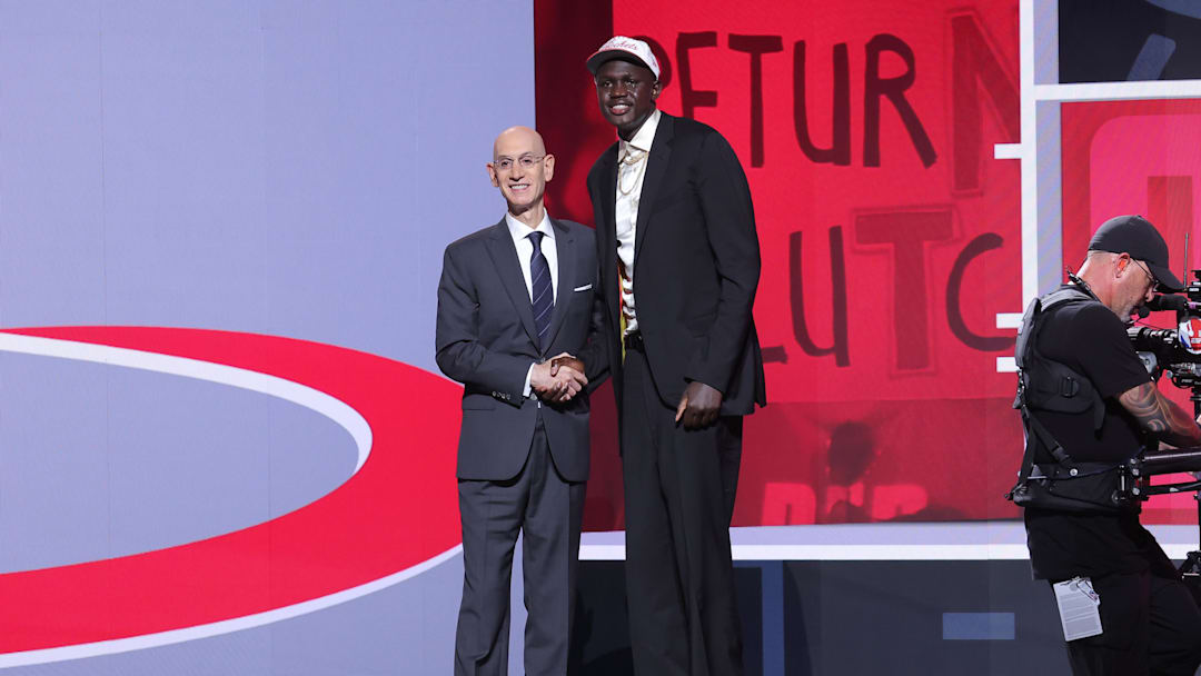 Jun 25, 2025; Brooklyn, NY;  Khaman Maluach stands with NBA commissioner Adam Silver during the first round of the 2025 NBA Draft