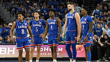 Dec 4, 2024; Omaha, Nebraska, USA; Kansas Jayhawks guard David Coit (8) and guard Dajuan Harris Jr. (3) and guard Rakease Passmore (4) and center Hunter Dickinson (1) and guard AJ Storr (2) on the floor against the Creighton Bluejays during the first half at CHI Health Center Omaha. Mandatory Credit: Steven Branscombe-Imagn Images