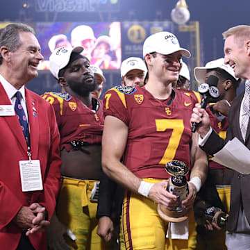 Dec 27, 2023; San Diego, CA, USA; USC Trojans quarterback Miller Moss (7) is presented the offensive MVP trophy after defeating the Louisville Cardinals at Petco Park. Mandatory Credit: Orlando Ramirez-USA TODAY Sports