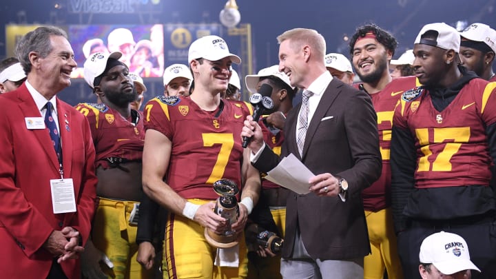 Dec 27, 2023; San Diego, CA, USA; USC Trojans quarterback Miller Moss (7) is presented the offensive MVP trophy after defeating the Louisville Cardinals at Petco Park. Mandatory Credit: Orlando Ramirez-USA TODAY Sports