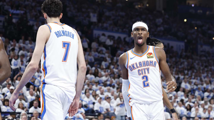 Apr 21, 2024; Oklahoma City, Oklahoma, USA; Oklahoma City Thunder guard Shai Gilgeous-Alexander (2) reacts to forward Chet Holmgren (7) blocking a shot by a New Orleans Pelicans player during the second quarter of game one of the first round for the 2024 NBA playoffs at Paycom Center. Mandatory Credit: Alonzo Adams-USA TODAY Sports