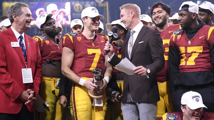 Dec 27, 2023; San Diego, CA, USA; USC Trojans quarterback Miller Moss (7) is presented the offensive MVP trophy after defeating the Louisville Cardinals at Petco Park. Mandatory Credit: Orlando Ramirez-USA TODAY Sports