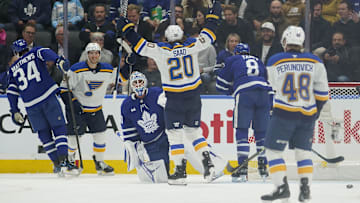 Oct 24, 2024; Toronto, Ontario, CAN; St. Louis Blues forward Brandon Saad (20) celebrates a goal by forward Dylan Holloway (81) against Toronto Maple Leafs goaltender Joseph Woll (60) during the first period at Scotiabank Arena. Mandatory Credit: John E. Sokolowski-Imagn Images