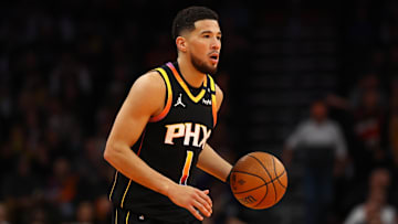 Nov 26, 2024; Phoenix, Arizona, USA; Phoenix Suns guard Devin Booker (1) against the Los Angeles Lakers during an NBA Cup game at Footprint Center. Mandatory Credit: Mark J. Rebilas-Imagn Images