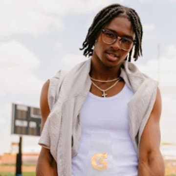 Tate Taylor poses with the 2025 Gatorade National Track and Field Player of the Year Award during a personalized photoshoot at San Antonio's John M. Harlan High School after he was surprised with the award on Thursday, July 26, 2025.