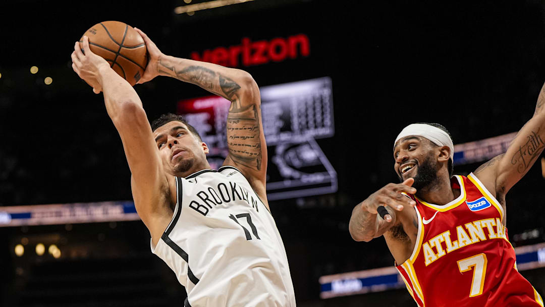 Feb 22, 2026; Atlanta, Georgia, USA; Brooklyn Nets forward Michael Porter Jr. (17) grabs a rebound over Atlanta Hawks guard Nickeil Alexander-Walker (7) during the second half at State Farm Arena. Mandatory Credit: Dale Zanine-Imagn Images