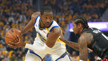 Apr 26, 2025; San Francisco, California, USA; Golden State Warriors forward Jonathan Kuminga (left) handles the ball against Houston Rockets guard Jalen Green (right) during the first quarter of game three of first round for the 2024 NBA Playoffs at Chase Center. Mandatory Credit: Darren Yamashita-Imagn Images