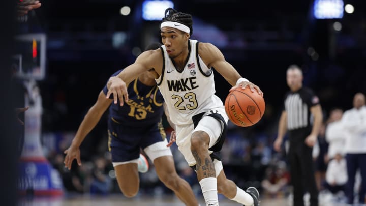 Mar 13, 2024; Washington, D.C., USA; Wake Forest Demon Deacons guard Hunter Sallis (23) drives to the basket past Notre Dame Fighting Irish forward Tae Davis (13) in the second half at Capital One Arena. Mandatory Credit: Geoff Burke-USA TODAY Sports