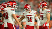 Oct 17, 2025; Miami Gardens, Florida, USA; Louisville Cardinals kicker Cooper Ranvier (36) celebrates with teammates after an extra point conversion against the Miami Hurricanes during the first quarter at Hard Rock Stadium. Mandatory Credit: Sam Navarro-Imagn Images