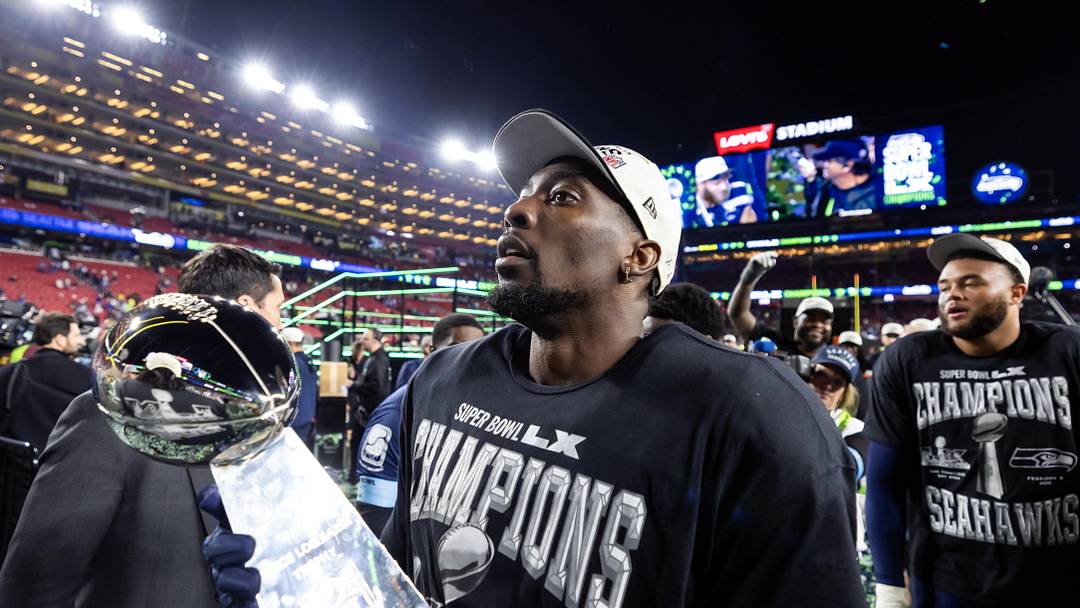 Feb 8, 2026; Santa Clara, CA, USA; Seattle Seahawks defensive end DeMarcus Lawrence (0) celebrates with the Vince Lombardi Trophy after defeating the New England Patriots during Super Bowl LX at Levi's Stadium. Mandatory Credit: Mark J. Rebilas-Imagn Images