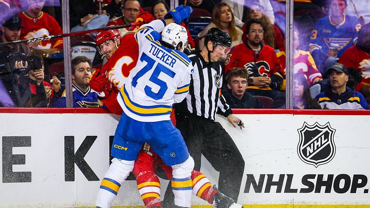Mar 18, 2026; Calgary, Alberta, CAN; St. Louis Blues defenseman Tyler Tucker (75) checks into the boards Calgary Flames right wing Adam Klapka (43) during the second period at Scotiabank Saddledome. Mandatory Credit: Sergei Belski-Imagn Images