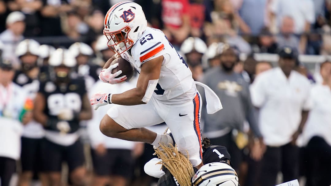 Auburn running back Jeremiah Cobb (23) is stopped by Vanderbilt safety CJ Heard (8) and safety Dontae Carter (1) during the second quarter at FirstBank Stadium in Nashville, Tenn., Saturday, Nov. 8, 2025. Auburn running back Jeremiah Cobb (23) is stopped by Vanderbilt safety CJ Heard (8) and safety Dontae Carter (1) during the second quarter at FirstBank Stadium in Nashville, Tenn., Saturday, Nov. 8, 2025.