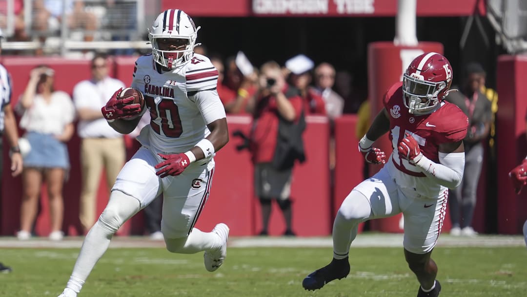 Oct 12, 2024; Tuscaloosa, Alabama, USA;  South Carolina Gamecocks tight end Michael Smith (20) runs away from Alabama Crimson Tide linebacker Justin Jefferson (15) at Bryant-Denny Stadium. Mandatory Credit: Gary Cosby Jr.-Imagn Images