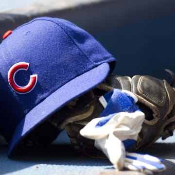 Apr 10, 2011; Milwaukee, WI, USA; Chicago Cubs hat and glove in the dugout prior to the game against the Milwaukee Brewers at Miller Park.  The Brewers defeated the Cubs 6-5.