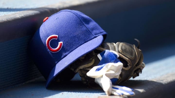 Apr 10, 2011; Milwaukee, WI, USA; Chicago Cubs hat and glove in the dugout prior to the game against the Milwaukee Brewers at Miller Park.  The Brewers defeated the Cubs 6-5.