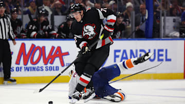 Nov 1, 2024; Buffalo, New York, USA;  Buffalo Sabres center Tage Thompson (72) takes the puck from New York Islanders defenseman Ryan Pulock (6) during the third period at KeyBank Center. Mandatory Credit: Timothy T. Ludwig-Imagn Images