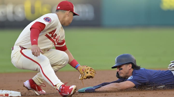 Jul 13, 2024; Anaheim, California, USA;  Josh Rojas #4 of the Seattle Mariners is caught stealing on tag by Keston Hiura #13 of the Los Angeles Angels in the second inning at Angel Stadium. Mandatory Credit: Jayne Kamin-Oncea-USA TODAY Sports