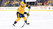 Oct 15, 2024; Nashville, Tennessee, USA;  Nashville Predators defenseman Dante Fabbro (57) takes a shot on goal against the Seattle Kraken during the first period at Bridgestone Arena. Mandatory Credit: Steve Roberts-Imagn Images