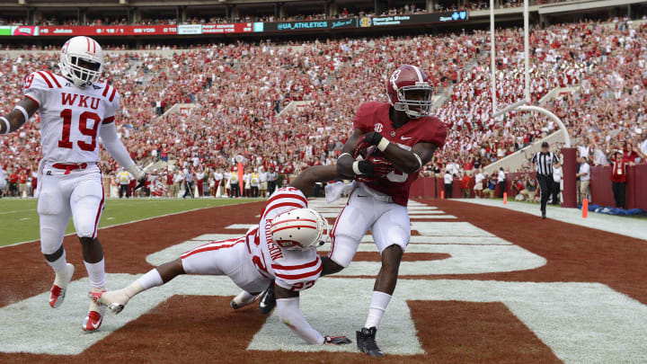 September 8, 2012; Tuscaloosa, AL, USA;  Alabama Crimson Tide wide receiver Christion Jones (22) pulls in a touchdown pass in the endzone over Western Kentucky Hilltoppers defensive back Tyree Robinson (22) during the second half at Bryant Denny Stadium. The Alabama Crimson Tide defeated the Western Kentucky Hilltoppers 35-0.  Mandatory Credit: John David Mercer-USA TODAY Sports