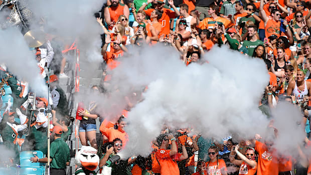 Miami Hurricanes football fans cheering in a game against Virgini