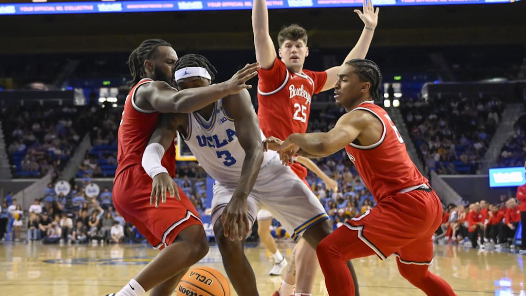 Feb 23, 2025; Los Angeles, California, USA; UCLA Bruins guard Eric Dailey Jr. (3) is defended by Ohio State Buckeyes guard Bruce Thornton (2), center Austin Parks (25) and guard Ques Glover (6) during the second half at Pauley Pavilion presented by Wescom. Mandatory Credit: Robert Hanashiro-Imagn Images