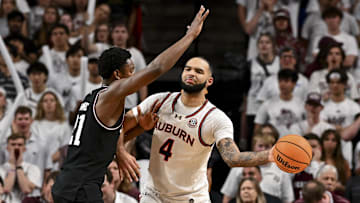 Mar 4, 2025; College Station, Texas, USA; Auburn Tigers forward Johni Broome (4) passes the ball as Texas A&M Aggies forward Pharrel Payne (21) defends during the first half at Reed Arena. Mandatory Credit: Maria Lysaker-Imagn Images 