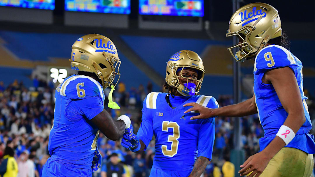 Nov 8, 2025; Pasadena, California, USA; UCLA Bruins running back Anthony Woods (6) celebrates his touchdown scored against the Nebraska Cornhuskers with wide receiver Kwazi Gilmer (3) and quarterback Nico Iamaleava (9) during the second half at the Rose Bowl. Mandatory Credit: Gary A. Vasquez-Imagn Images