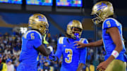 Nov 8, 2025; Pasadena, California, USA; UCLA Bruins running back Anthony Woods (6) celebrates his touchdown scored against the Nebraska Cornhuskers with wide receiver Kwazi Gilmer (3) and quarterback Nico Iamaleava (9) during the second half at the Rose Bowl. Mandatory Credit: Gary A. Vasquez-Imagn Images