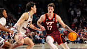 Dec 2, 2025; Columbia, South Carolina, USA; Virginia Tech Hokies guard Neoklis Avdalas (17) drives around South Carolina Gamecocks guard Mike Sharavjamts (55) in the second half at Colonial Life Arena. Mandatory Credit: Jeff Blake-Imagn Images