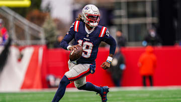 Jan 5, 2025; Foxborough, Massachusetts, USA; New England Patriots quarterback Joe Milton III (19) runs the ball against the Buffalo Bills in the first half at Gillette Stadium. Mandatory Credit: David Butler II-Imagn Images