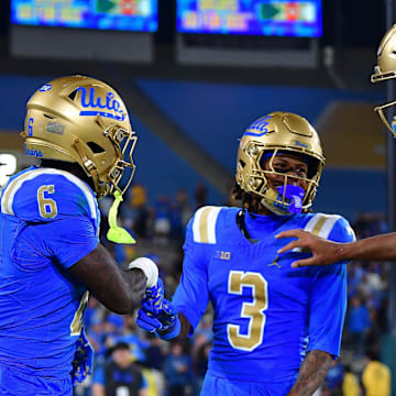 Nov 8, 2025; Pasadena, California, USA; UCLA Bruins running back Anthony Woods (6) celebrates his touchdown scored against the Nebraska Cornhuskers with wide receiver Kwazi Gilmer (3) and quarterback Nico Iamaleava (9) during the second half at the Rose Bowl. Mandatory Credit: Gary A. Vasquez-Imagn Images