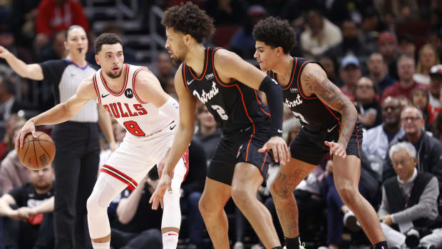 Bulls star Zach LaVine is guarded by Detroit Pistons star Cade Cunningham. 